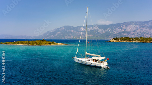 White yacht in the Aegean sea near the islands.
