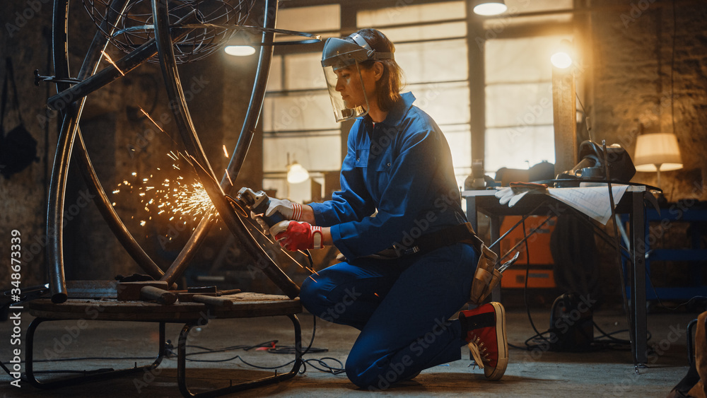 Fototapeta premium Young Contemporary Female Artist is Contemplating a Sculpture She Just Did and Feeling Proud About the Piece of Art. Empowering Woman Makes Modern Brutal Abstract Artwork Out Of Metal.