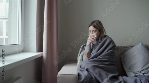 A girl with tired eyes sits opposite the onk. He is sick and blows his nose. Symptom of Orvi, coronavirus influenza, acute respiratory infections, sinusitis photo