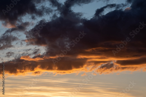 Fototapeta Naklejka Na Ścianę i Meble -  dark clouds on the blue sky and the pink light