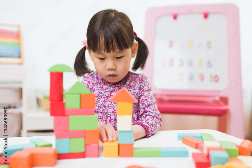 toddler girl playing creative toy blocks at home against white background toddler girl playing creative toy blocks at home against white background