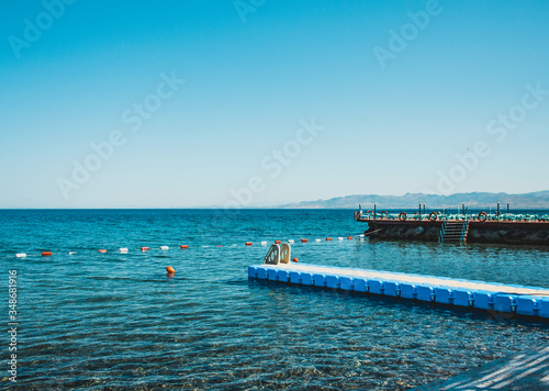 Sea pier without people and ships. Blue sky