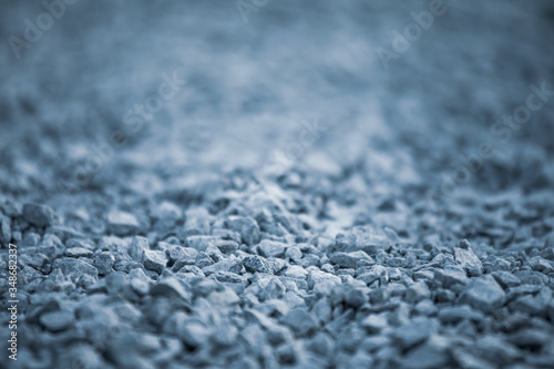 Background of pebbles. Pebble texture with a blue tint. Decorative rocks. Blue stone floor in the garden. Blue pebbles.