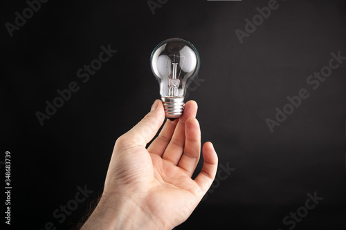  hand holds a light bulb, idea 