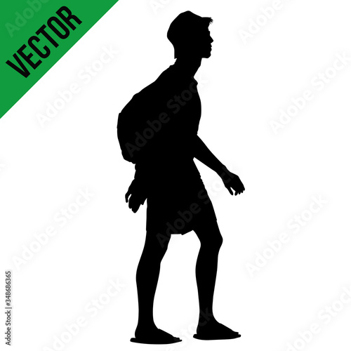 Young man silhouette with backpack walking