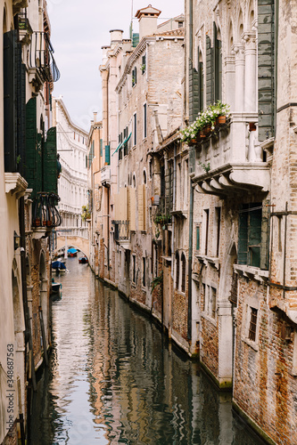 A narrow canal in Venice. Small canals between houses, a few meters. Beautiful little bridges between the streets.