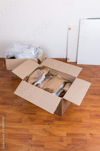 Moving boxes with packing material for fragile items on the floor