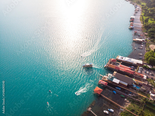 Aerial view of the coatepeque lake in El Salvador, where you can see the mountains that surround the lake, a sky almost clear only with some clouds, in the season where its waters turn turquoise.