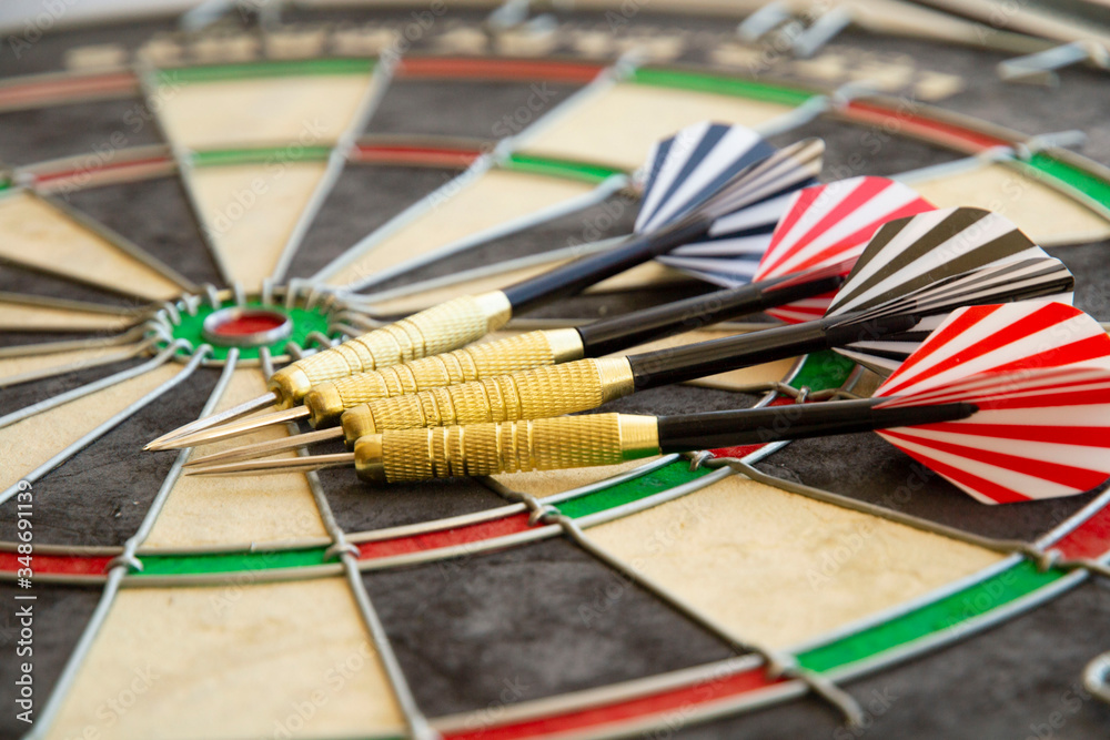 darts plumage with colored stripes lie on the darts board. game and competition concept. darts plumage with colored stripes lie on the darts board. game and competition concept.