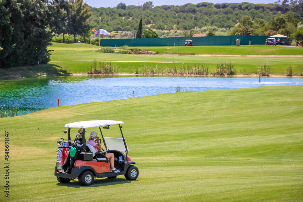 Golfer driving a Golf buggy at Quinta do Lago. Algarve - Portugal