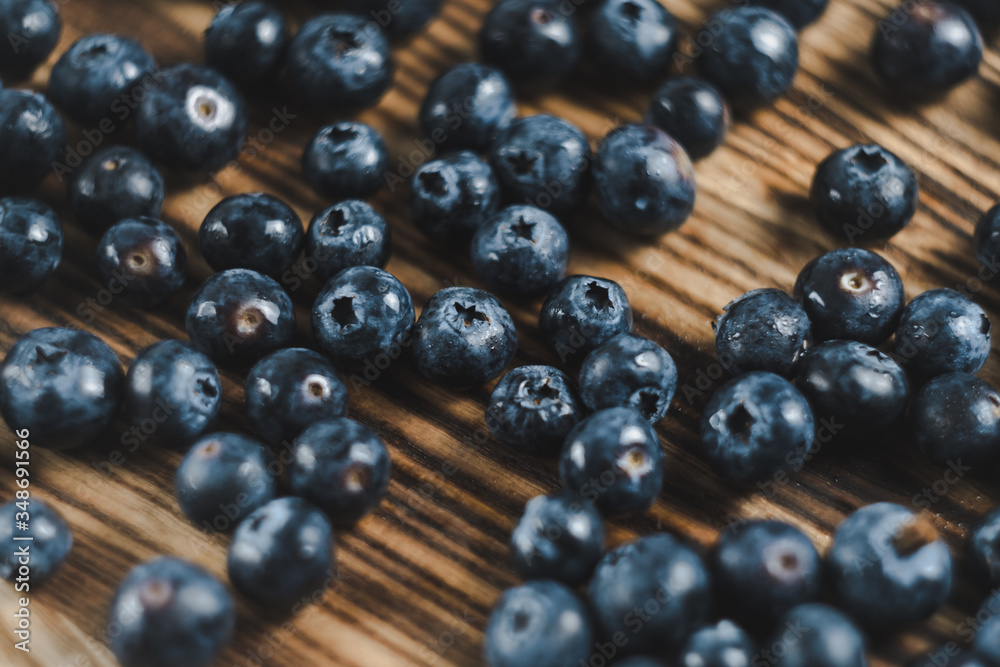 Fresh juicy blueberries on wooden board. Close up Fresh juicy blueberries on wooden board. Close up