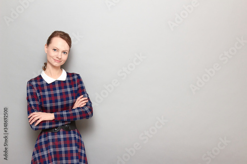 Portrait of happy friendly girl holding arms folded and smiling