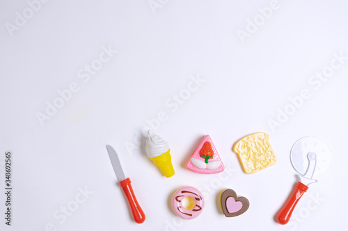 Collection of food toys for kids. Ice cream, slice of cake, donuts. Flay lay image. White background © acaimoron