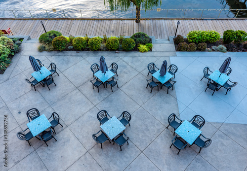 A birds eye view of empty tables outside a restaurant by the lake in Kelowna Canada