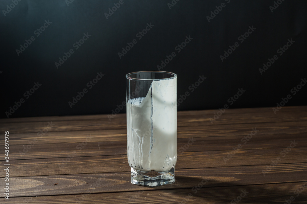 An empty glass of milk is standing on the table. An empty glass of milk is standing on the table.