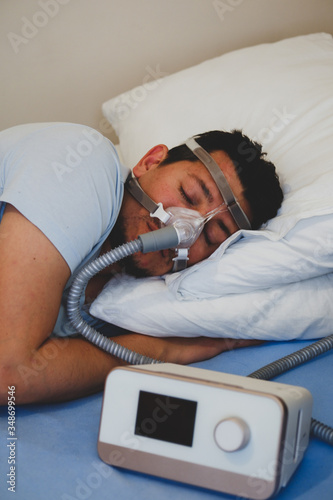 COVID-19 Pandemic Coronavirus; Close-up of young man using respirator machine for breathing.