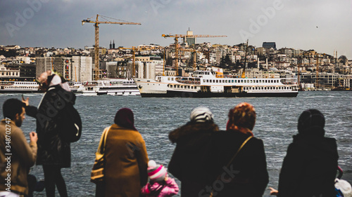 architecture ,structures ,construction, buildings, cranes, people, sea, boat, rainy day, cloudy, Istanbul