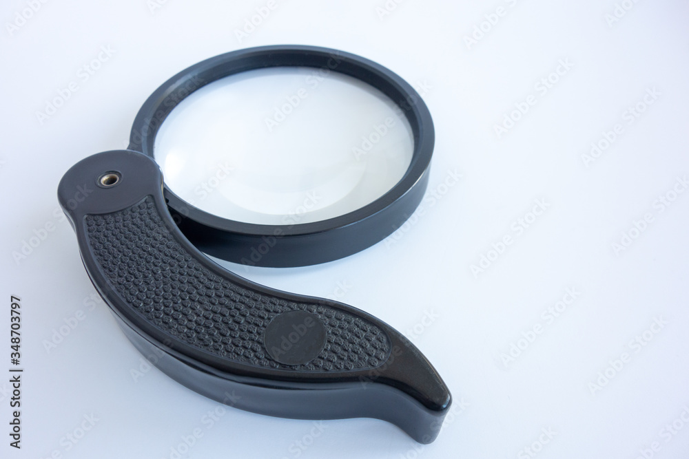 Magnifying glass with black handle, folding on white isolate Magnifying glass with black handle, folding on white isolate