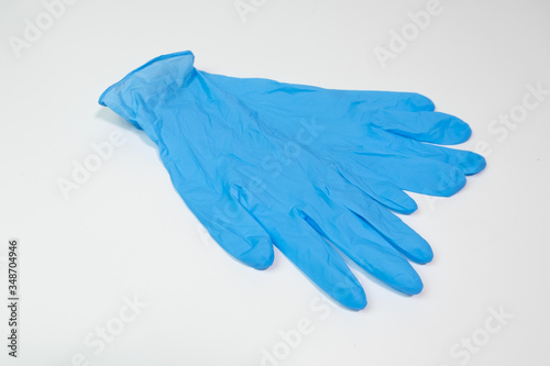 Blue nitrile medical gloves on white table © Barry
