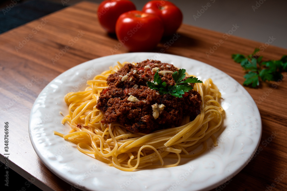 
Bolognese spaghetti in a porcelain plate with decoration