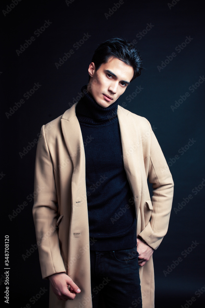 Fototapeta premium handsome asian fashion looking man posing in studio on black background, lifestyle modern people concept