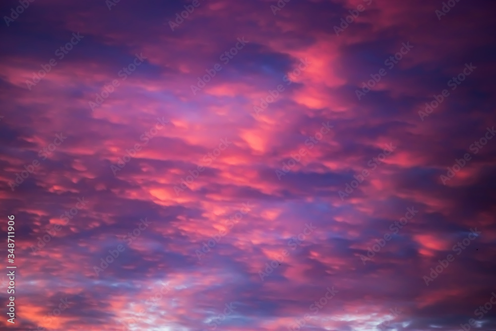 Beautiful sunset on the sky. Purple clouds in the sun. Blurred background for design. Selective focus.