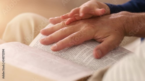 Grandpa Reading to Baby Boy From the Bible