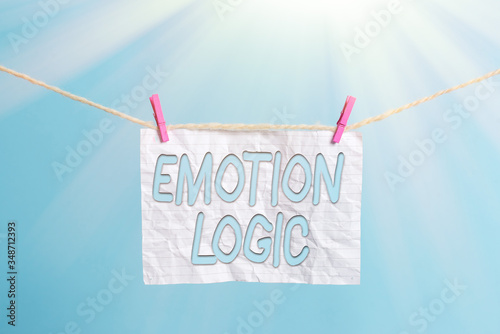 Handwriting text Emotion Logic. Conceptual photo Heart or Brain Soul or Intelligence Confusion Equal Balance Clothesline clothespin rectangle shaped paper reminder white wood desk photo