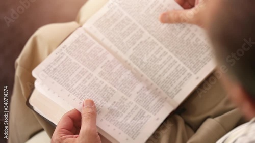 Close Up of a Man Reading the Holy Bible