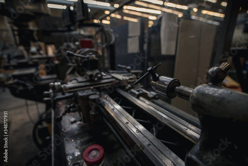 Lathe in a machine shop for building and repairing things with depth of field and reflection