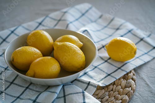 Bowl with fresh lemons on the soft cotton napkin. concept of natural healthy food and farm