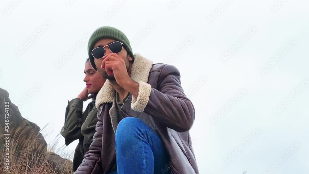 couple next to each other in foggy nature, boy removes sunglasses, girl smiles couple next to each other in foggy nature, boy removes sunglasses, girl smiles