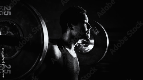 Photos asian strong athletic man having workout and bodybuilding with barbells weight l