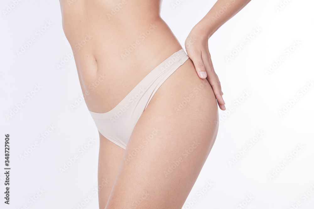 Slim tanned woman Perfect Body . Slim toned young body of the girl . An example for sports and fitness or plastic surgery and aesthetic cosmetology. Slim tanned woman Perfect Body . Slim toned young body of the girl . An example for sports and fitness or plastic surgery and aesthetic cosmetology.