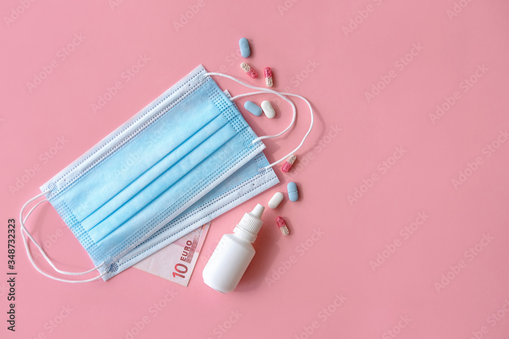 Flat lay composition with masks and pills on pink background. Flat lay composition with masks and pills on pink background.