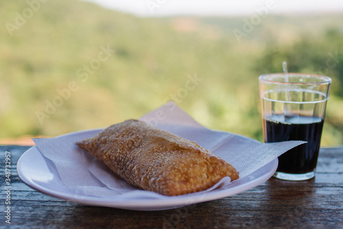 Pastel frito com café coado em copo americano, Minas Gerais, Brasil photo