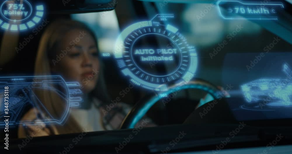 Woman engaging self driving mode in car