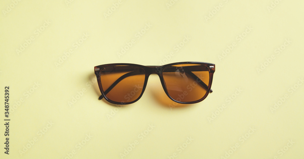 Stylish sunglasses on yellow background. Stylish sunglasses on yellow background.