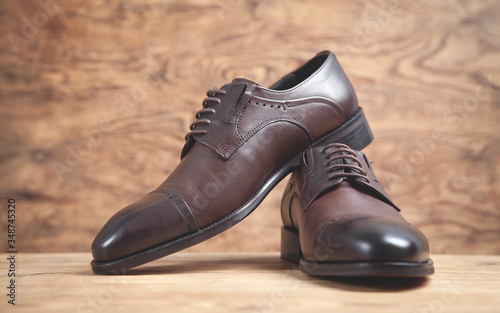 Brown shoes on the wooden background.