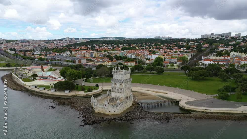 Aerial, tilt down, drone shot towards empty Torre de Belem fortification, partly sunny day, in Lisboa, Portugal Aerial, tilt down, drone shot towards empty Torre de Belem fortification, partly sunny day, in Lisboa, Portugal