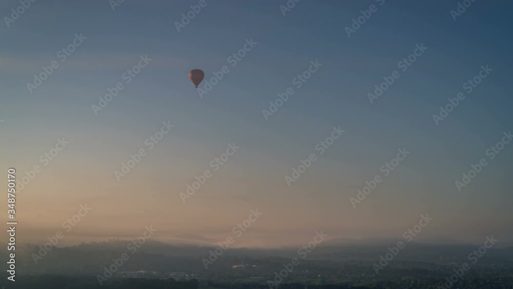 Time lapse of a hot air balloon flying through the clouds over a beautiful landscape in Canberra, Australia. Time lapse of a hot air balloon flying through the clouds over a beautiful landscape in Canberra, Australia.