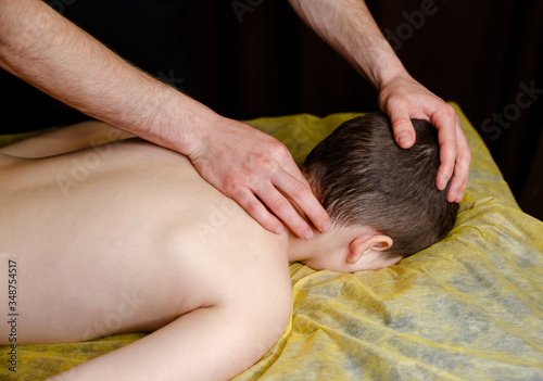 Cute kid having back massage in a children rehabilitation center