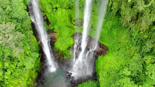 Drone Aerial of multiple cascading waterfalls surrounded by foliage in tropical paradise photo