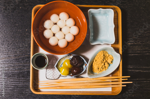 Traditional Japanses dessert made from sticky rice flour and brown sugar on wooden table photo