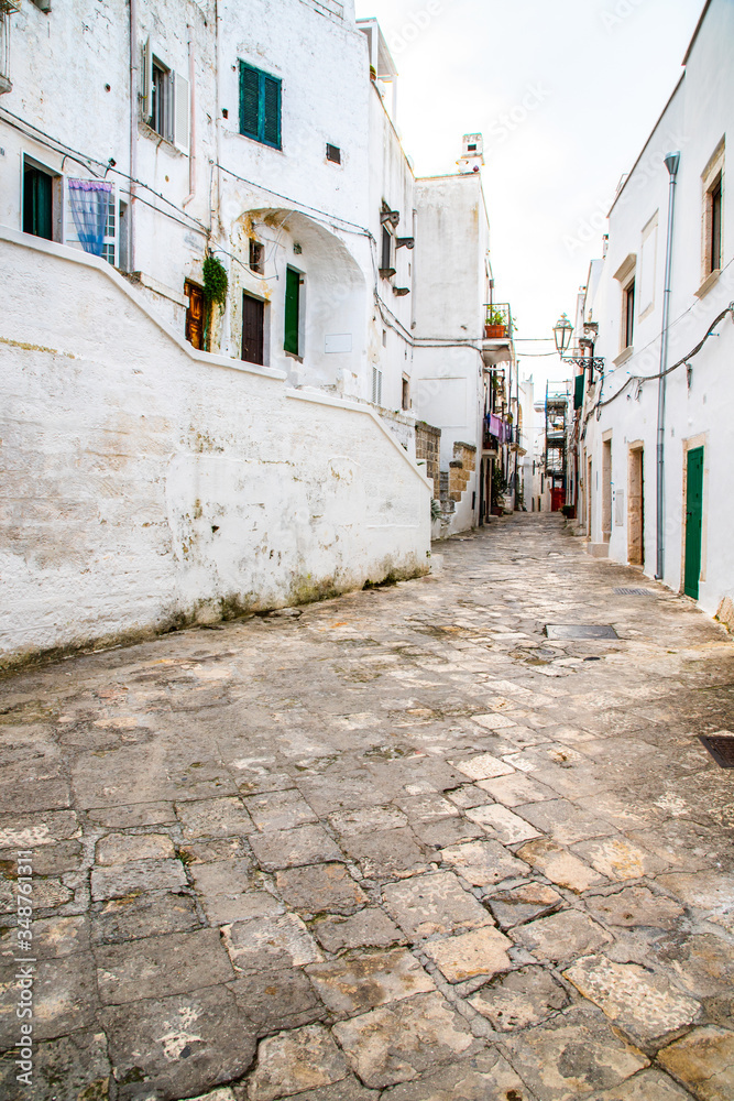 A public street with traditional houses in the old town area of the city center in Ostuni, South Italy A public street with traditional houses in the old town area of the city center in Ostuni, South Italy