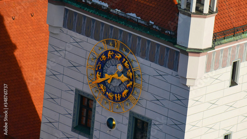 Gold watch with zodiac signs on the Old town hall in the center of Munich. Sights of Munich, located on the East side of Marienplatz square. Symbols of Aries, Libra, Pisces and other signs.