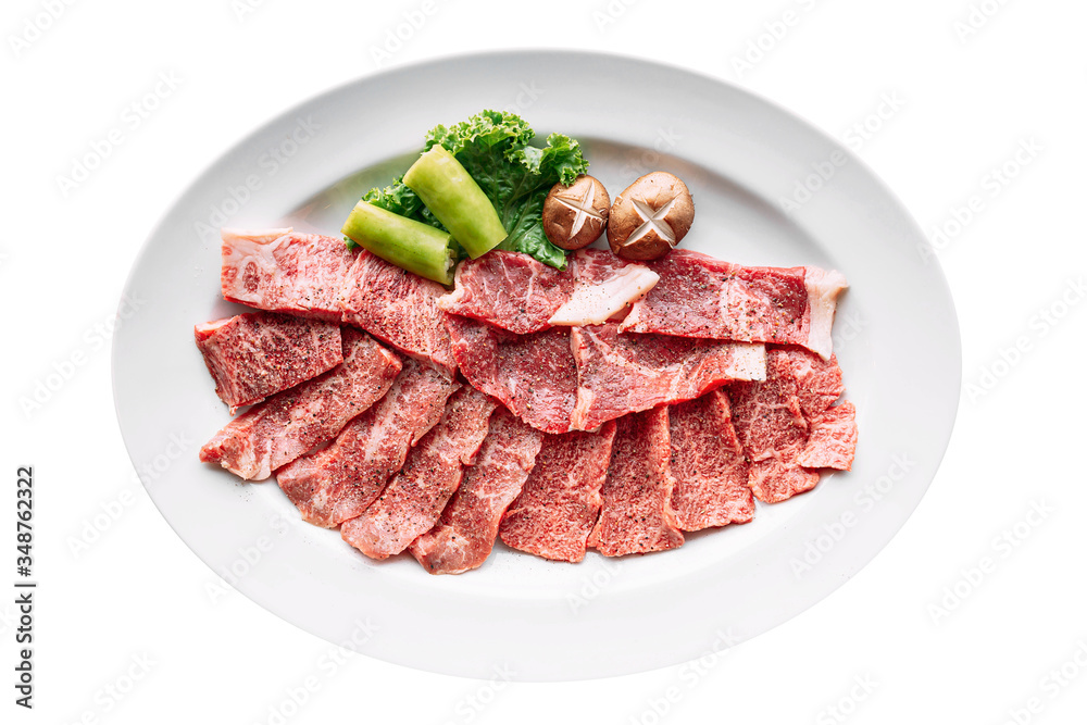 Isolated of Premium Rare Dry-Aged beef with high-marbled texture marinated with pepper and salt on white plate served for Yakiniku. Isolated of Premium Rare Dry-Aged beef with high-marbled texture marinated with pepper and salt on white plate served for Yakiniku.