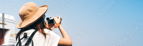 Young asian woman traveller with camera for banner size background.