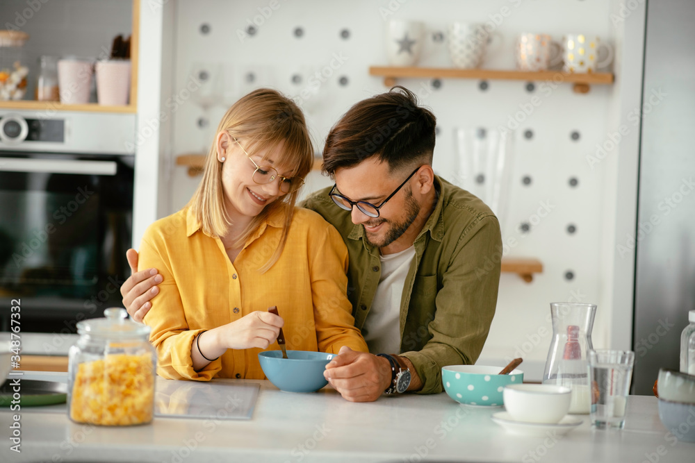Young couple making breakfast at home. Loving couple enjoying in morning.. Young couple making breakfast at home. Loving couple enjoying in morning..