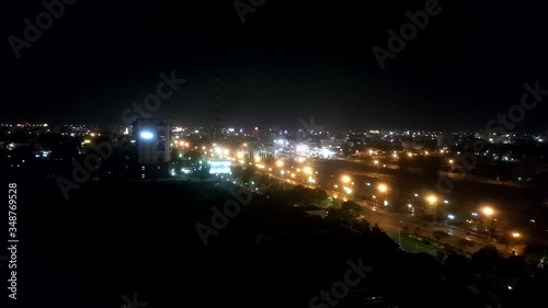 Timelapse of town night life in Phan Thiet, Vietnam. Bright lights of the city and a lively flow of cars on the streets.